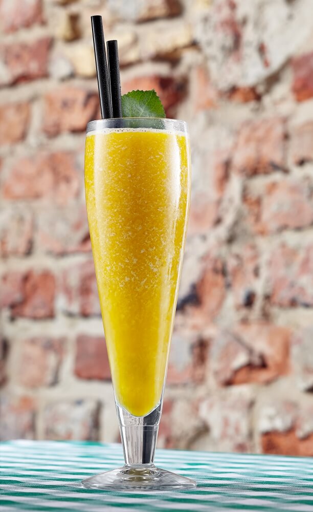 a photo of fruit cocktail on a brick wall background