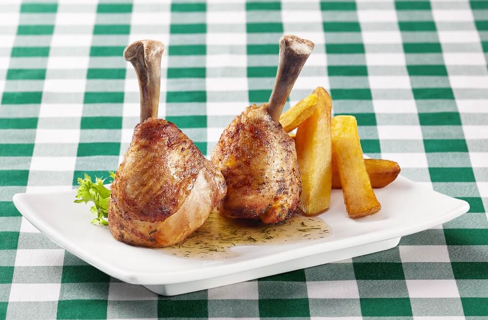 a photo of roasted meal on a plate laying on a green striped tablecloth
shot to be included in restaurant menu