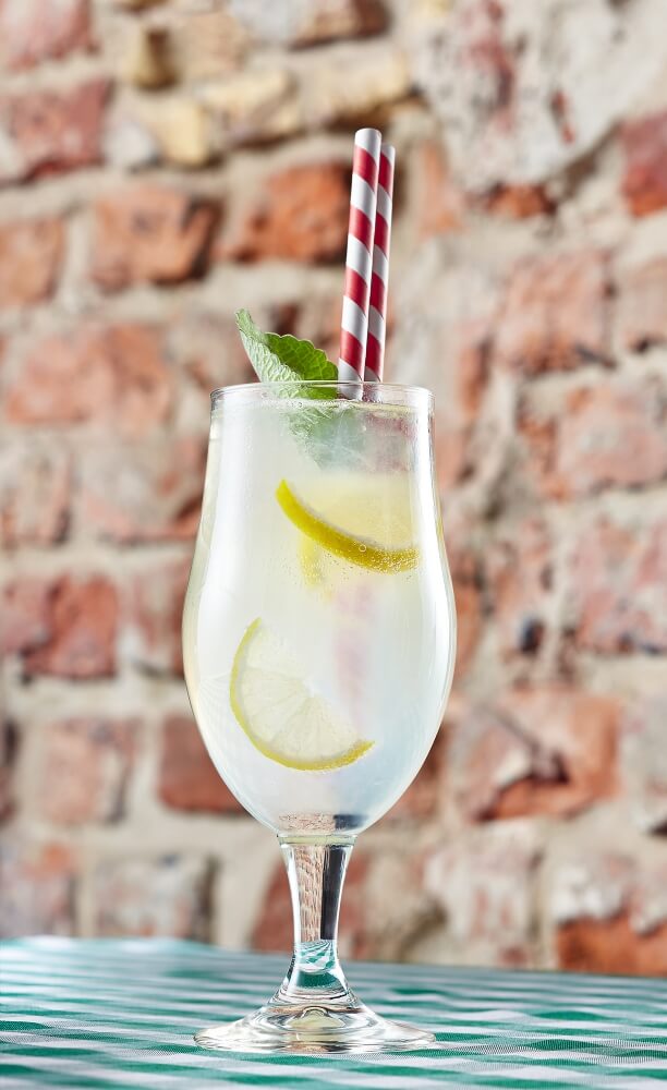 lemonade with lemon slices and mint inside shot in the interior of Bohemia restaurant in Gdańsk