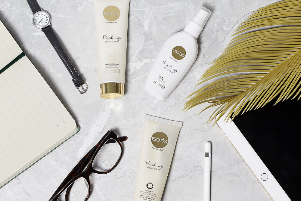 a photo of three Esotiq body care cosmetics on white marble with office stylization