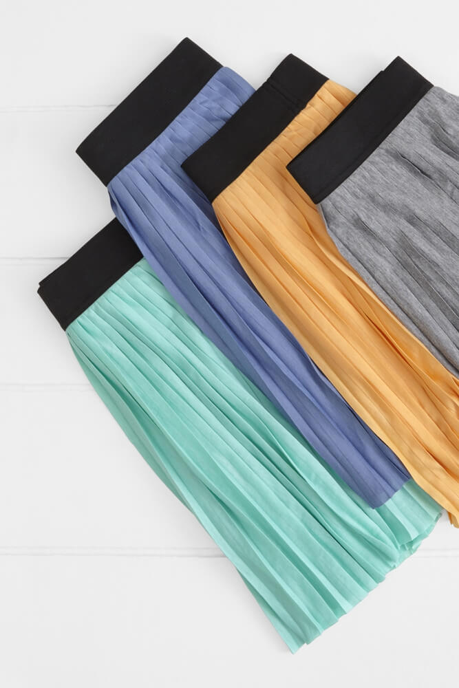 flat lay photo of different color variations of an House Brand skirt
