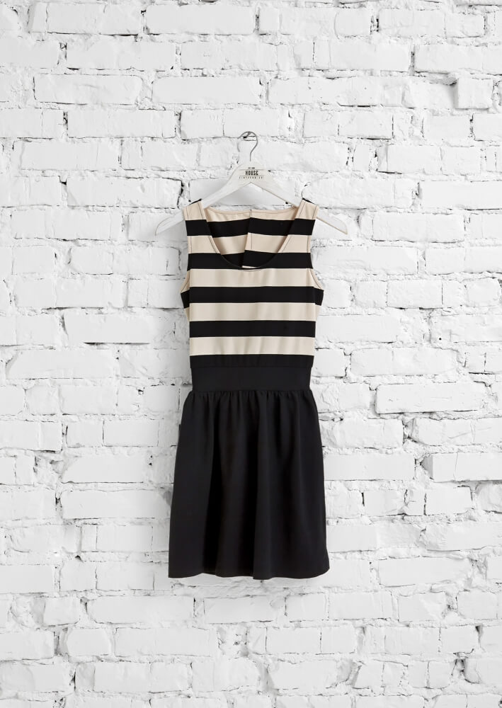 a photo of an skirt with an white brick wall background