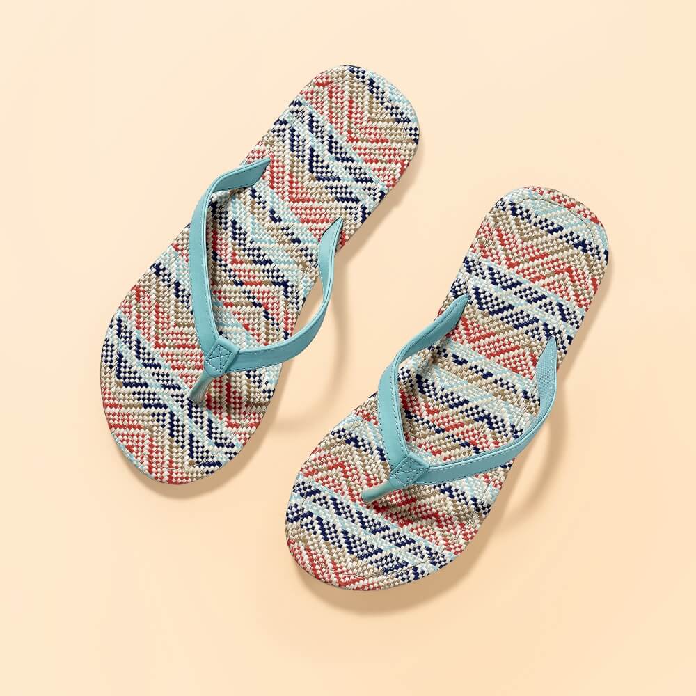 top view of a pair of House flip-flops on a beige background