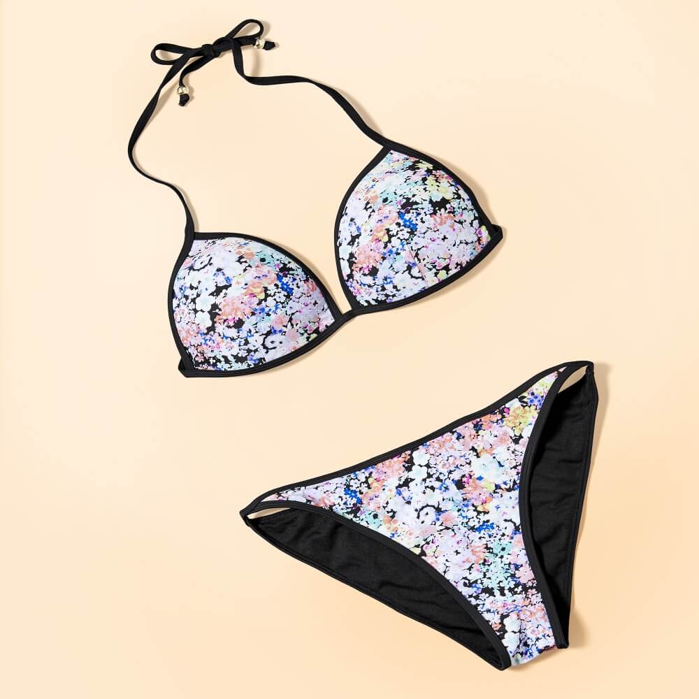 flat lay photo of House swimsuit on light yellow background