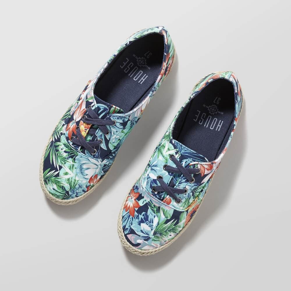 a photo of a pair of House shoes with multi-colored patterns on a gray background