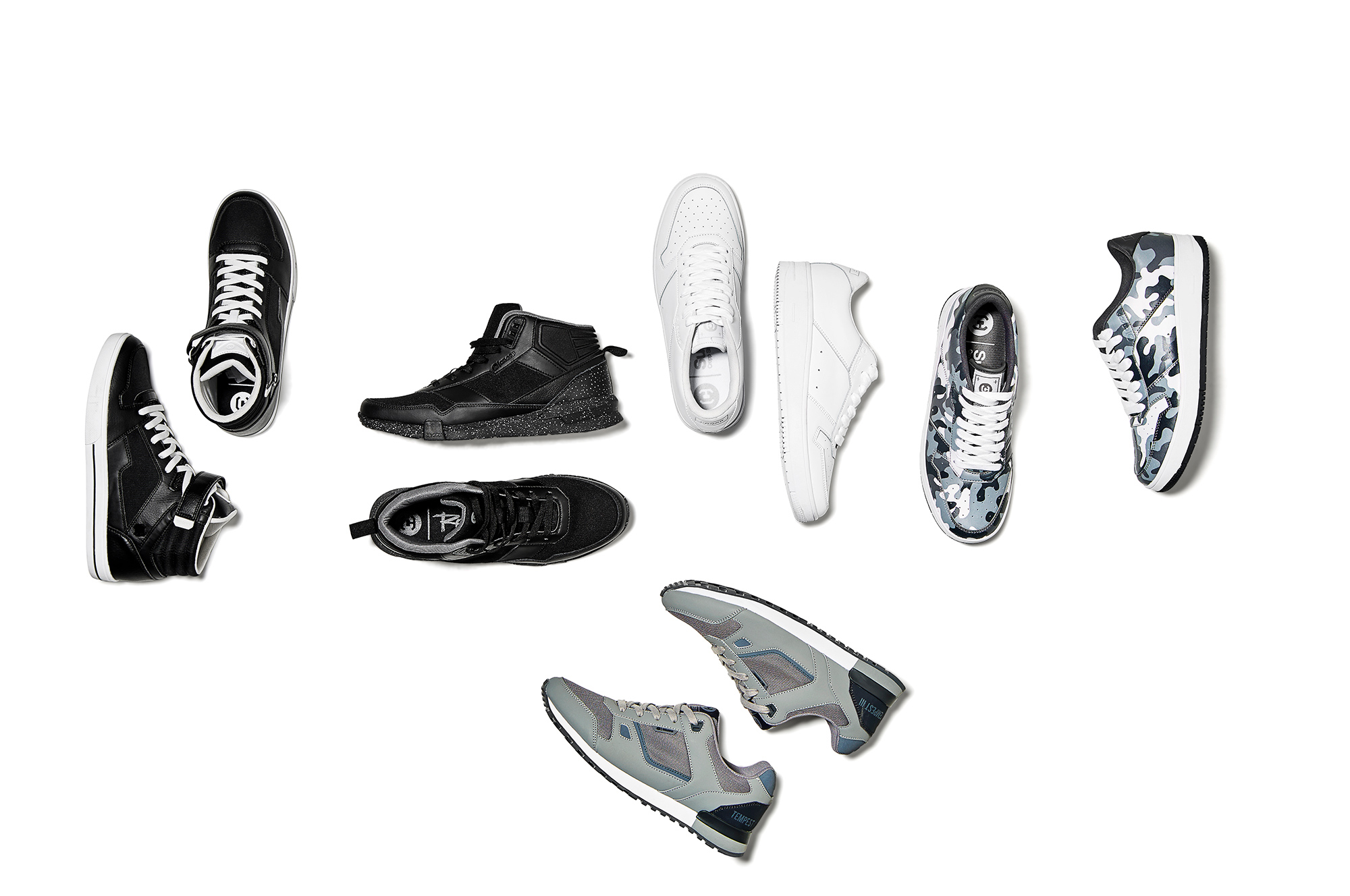 flat lay composition of five pairs of shoes on white background