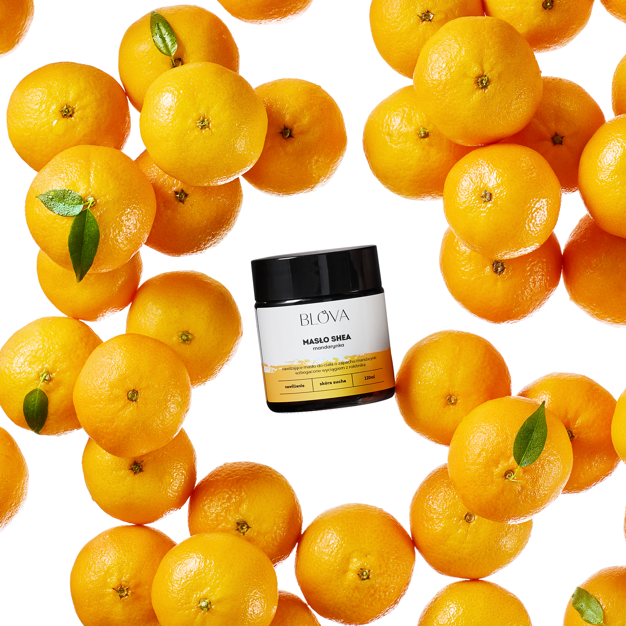photo of tangerine shea butter laid among fruits on a bright white background