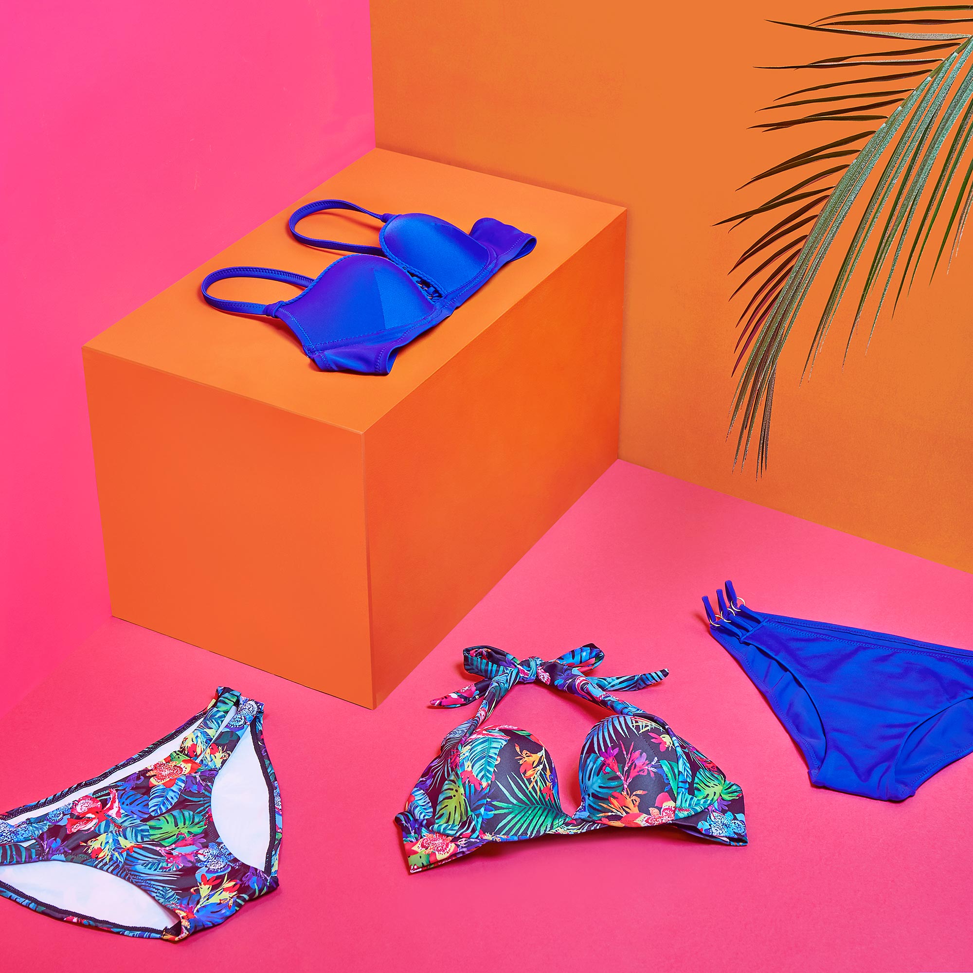 creative photo of Esotiq swimsuit placed in a geometric set in neon colours
