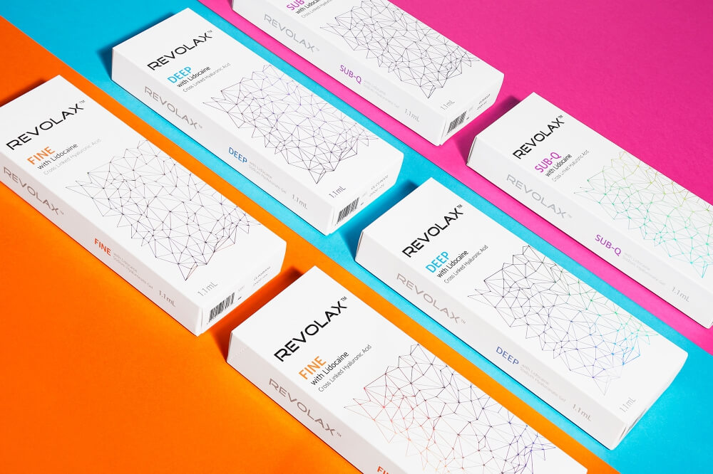 a photo of cosmetics packaging on a three cloured backround corresponding to the colours of packages