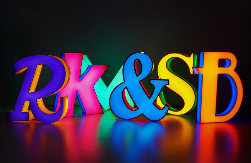 glowing letter light coffers on a black shiny floor and background